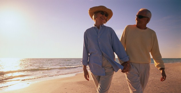 Older Couple Walking Along Beach